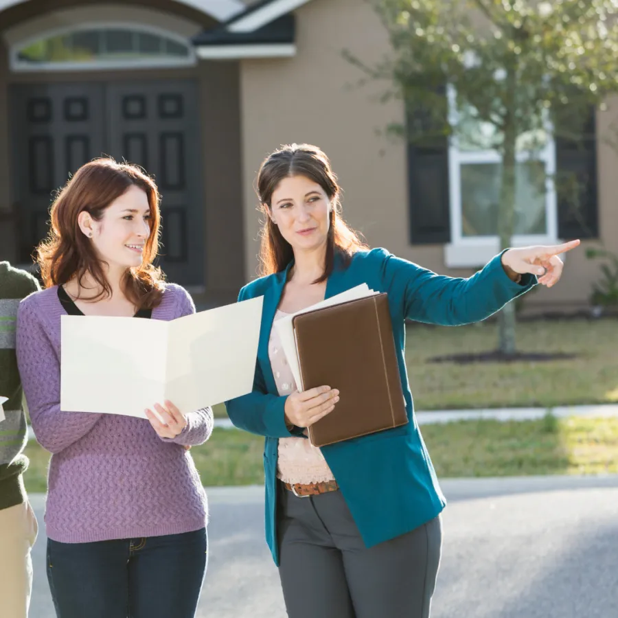 A family engages with a realtor in a bright, welcoming home setting.