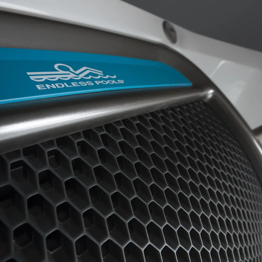 Close-up of a metal hexagonal grill with Endless Pools logo on a blue label above it.