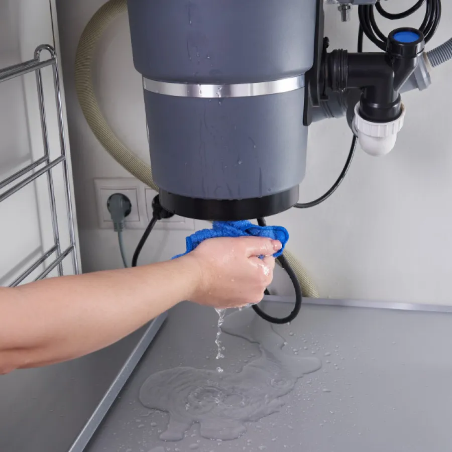 a plumber fixing a garbage disposal
