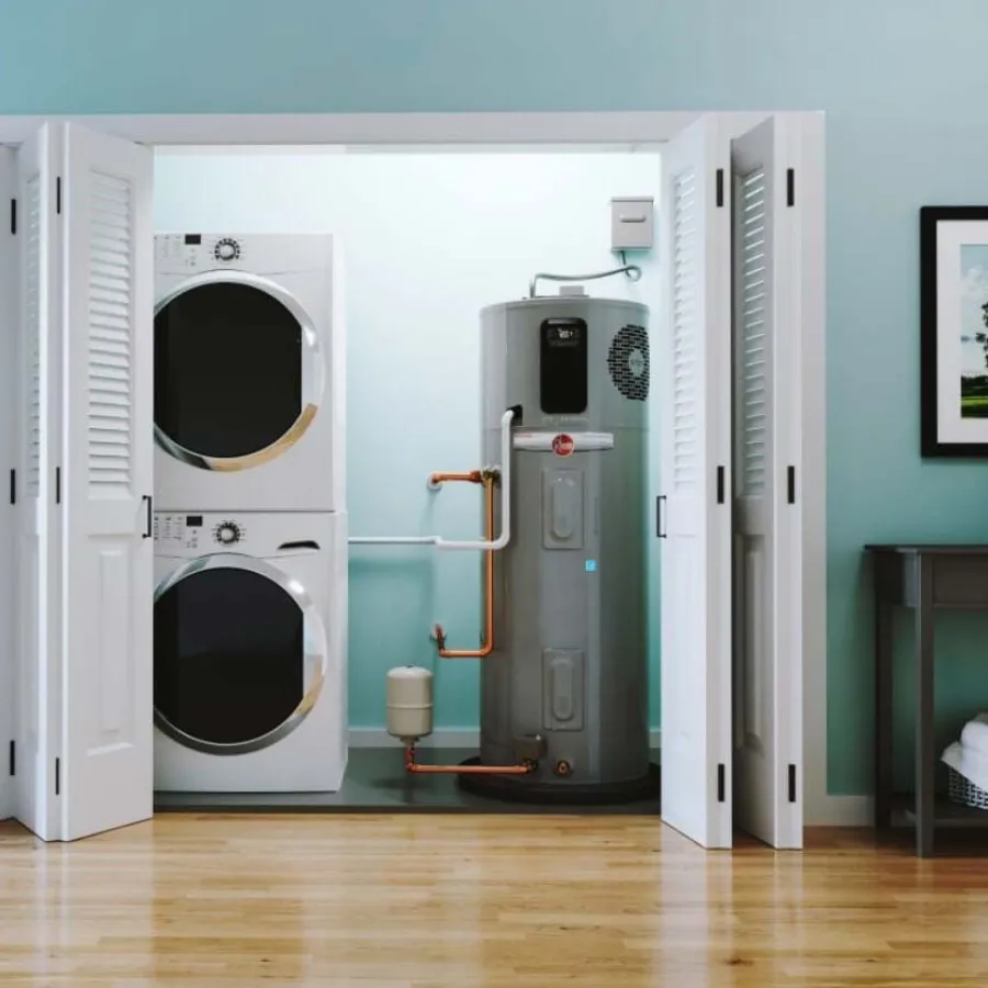 a room with a white wall and a white cabinet with a black and silver machine and a white