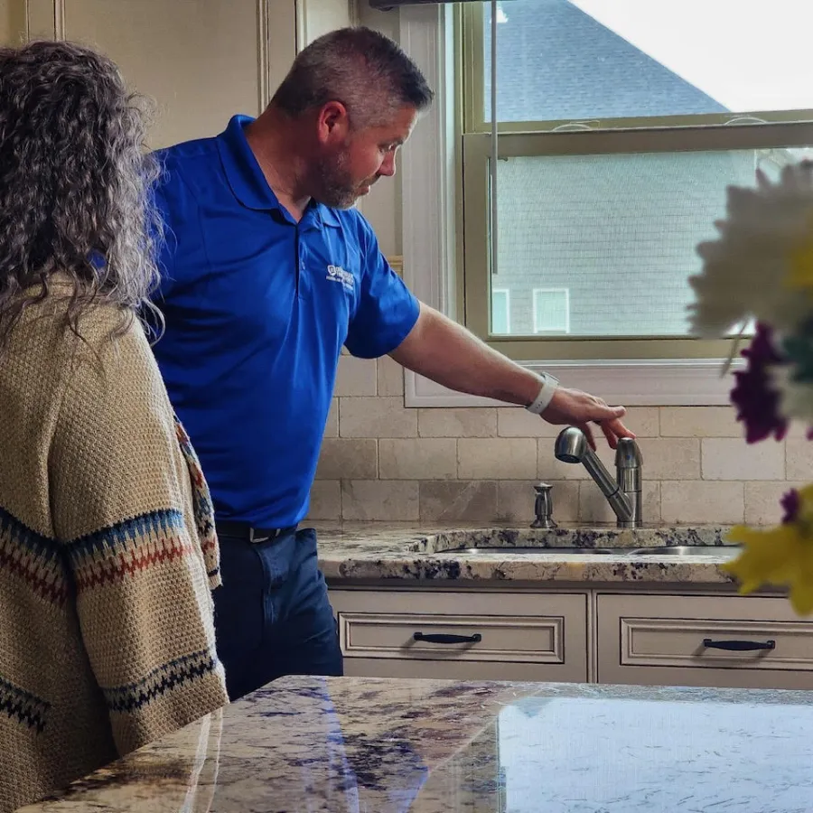 a man and a woman at the kitchen sink