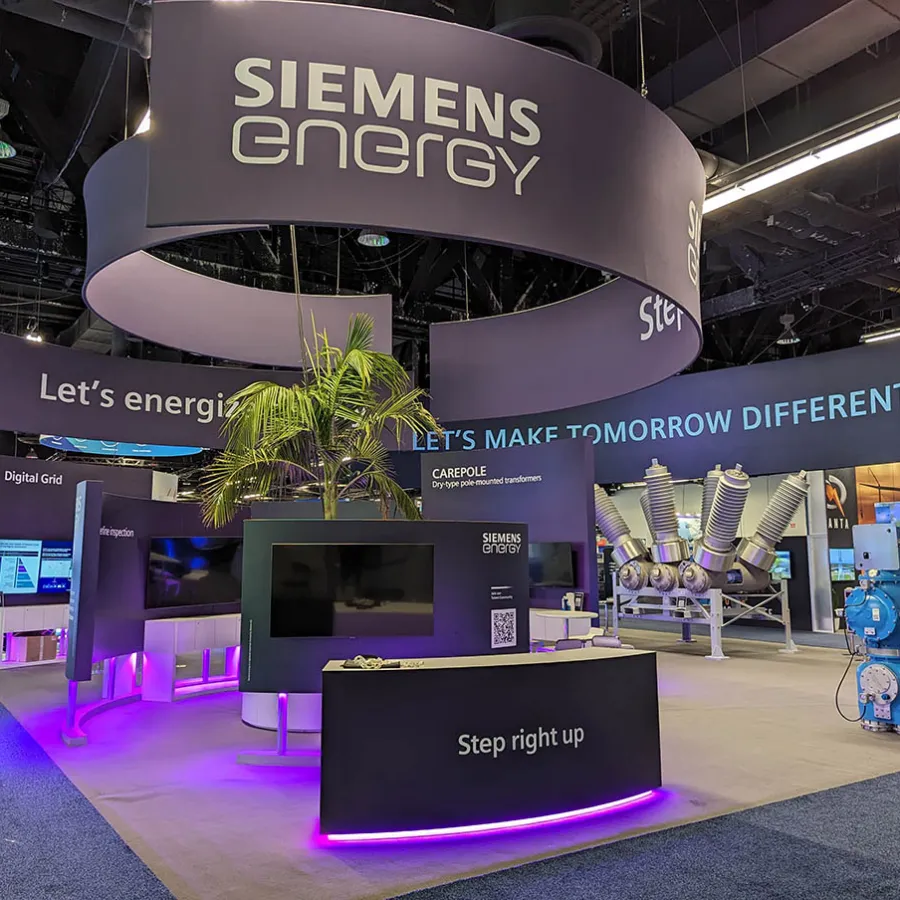 Siemens Energy exhibition booth with digital displays, modern equipment, and illuminated signage at trade show.