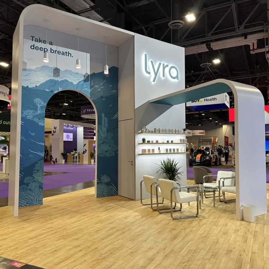 Lyra exhibition booth with blue arch, slogan 'Take a deep breath,' seating area, and modern design at trade show.