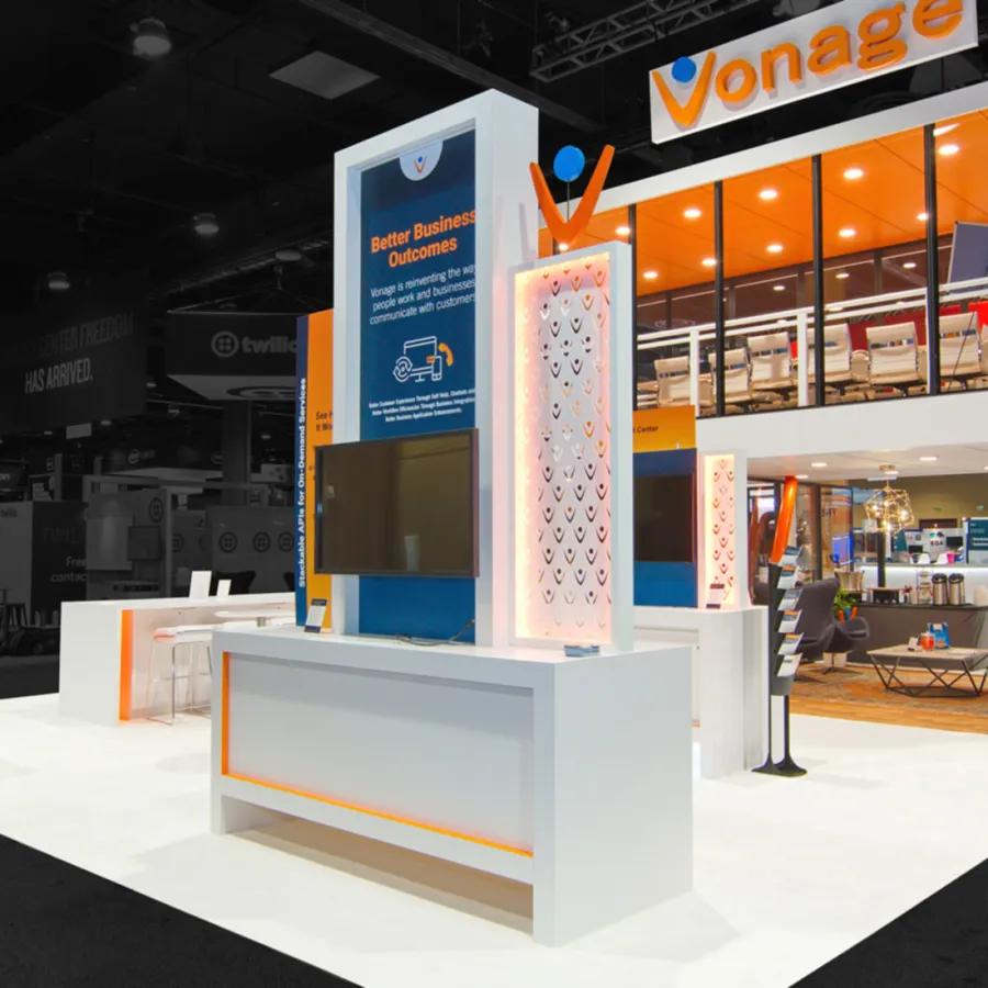 Modern Vonage trade show booth with two-level design, bright orange accents, and digital displays at a business expo.