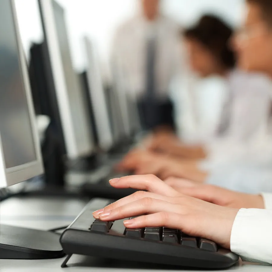 a close-up of a person typing on a keyboard