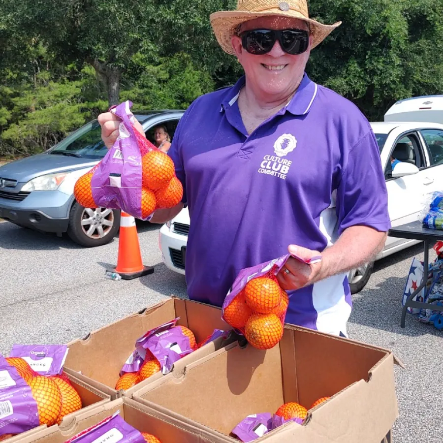 a person holding a box of fruit