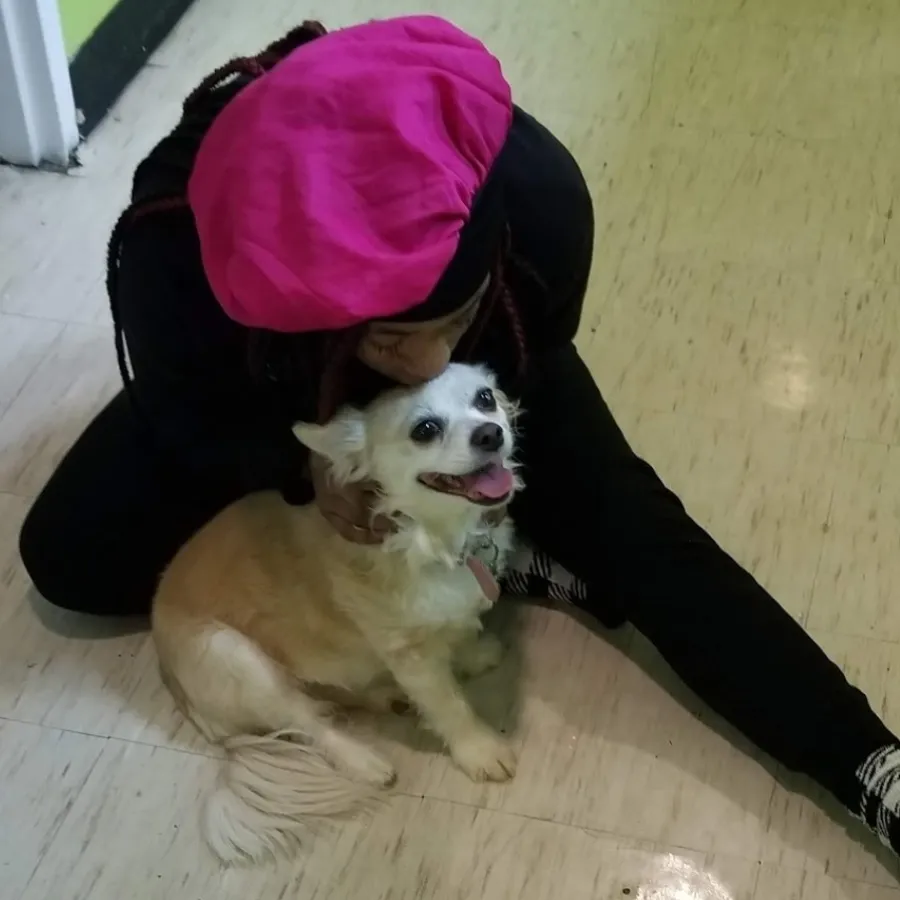a person in a garment with a dog
