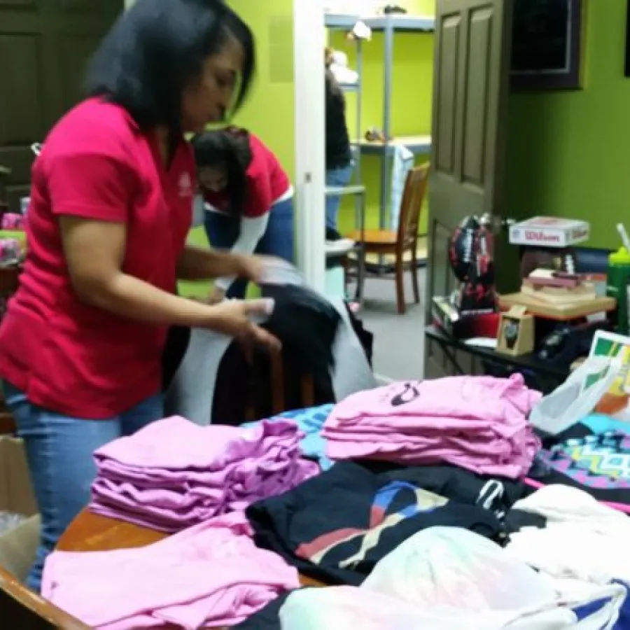 a person in a room with clothes on the floor