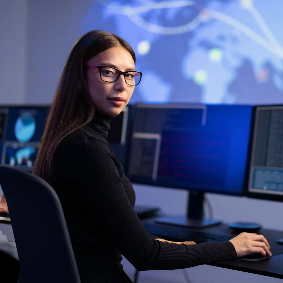 a woman sitting at a desk with a computer