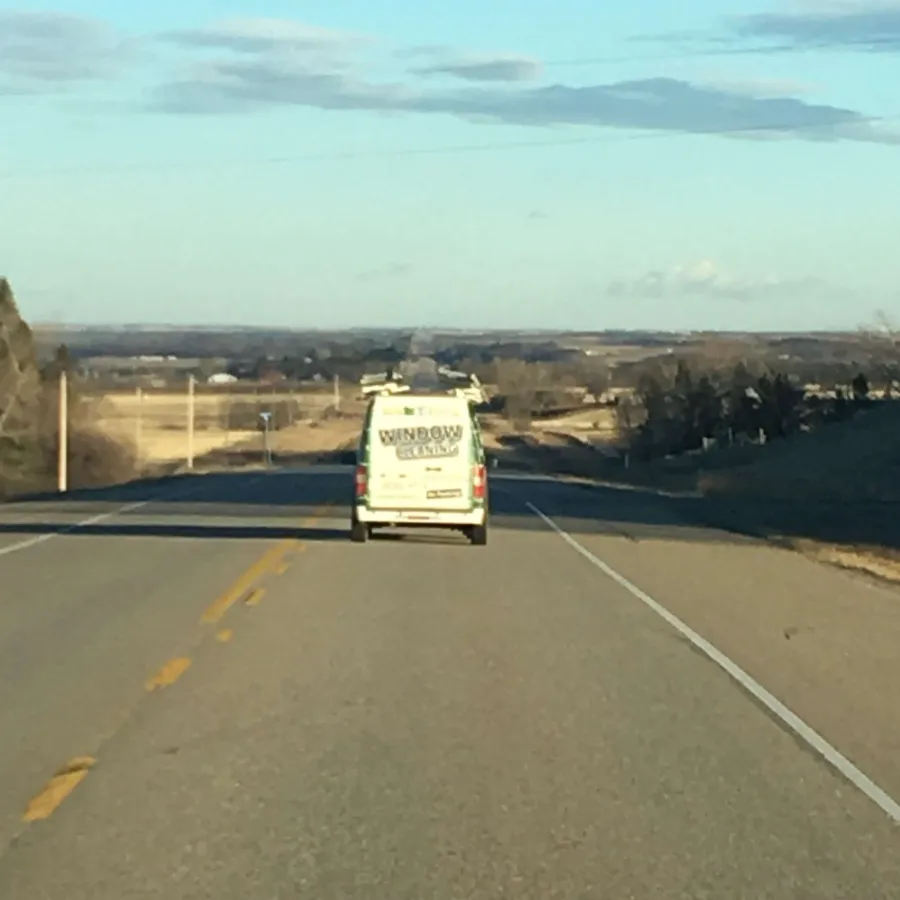 a white truck driving down a road