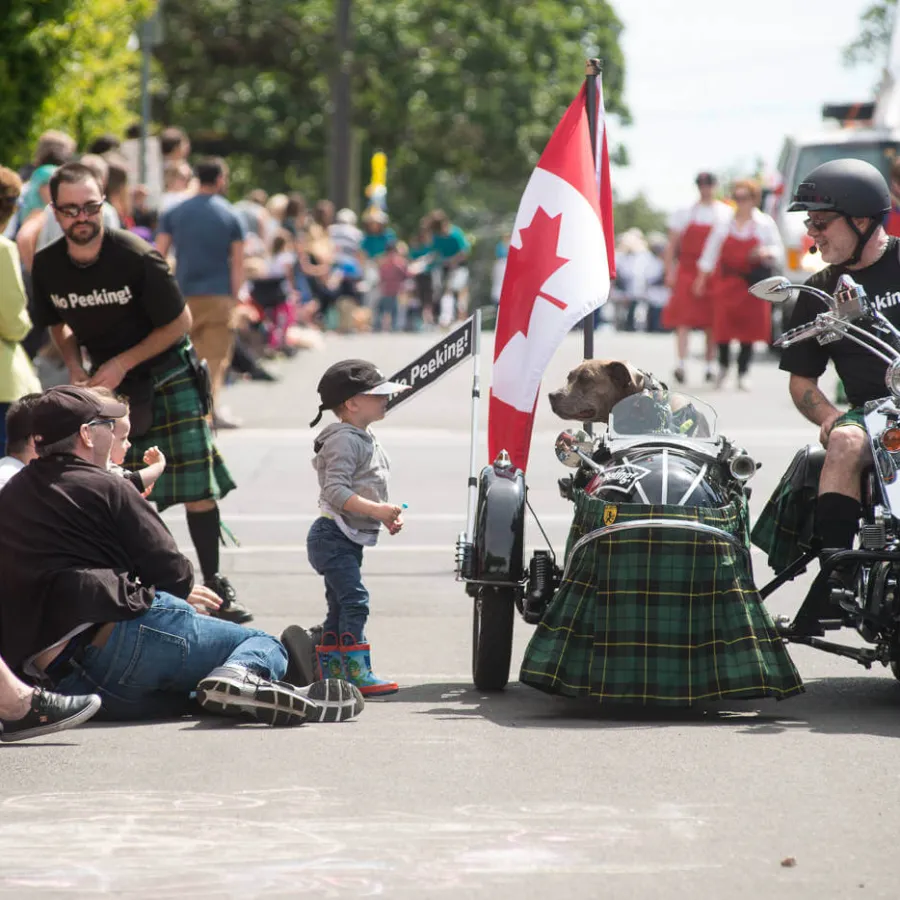 a person on a motorcycle with a flag in front of a crowd