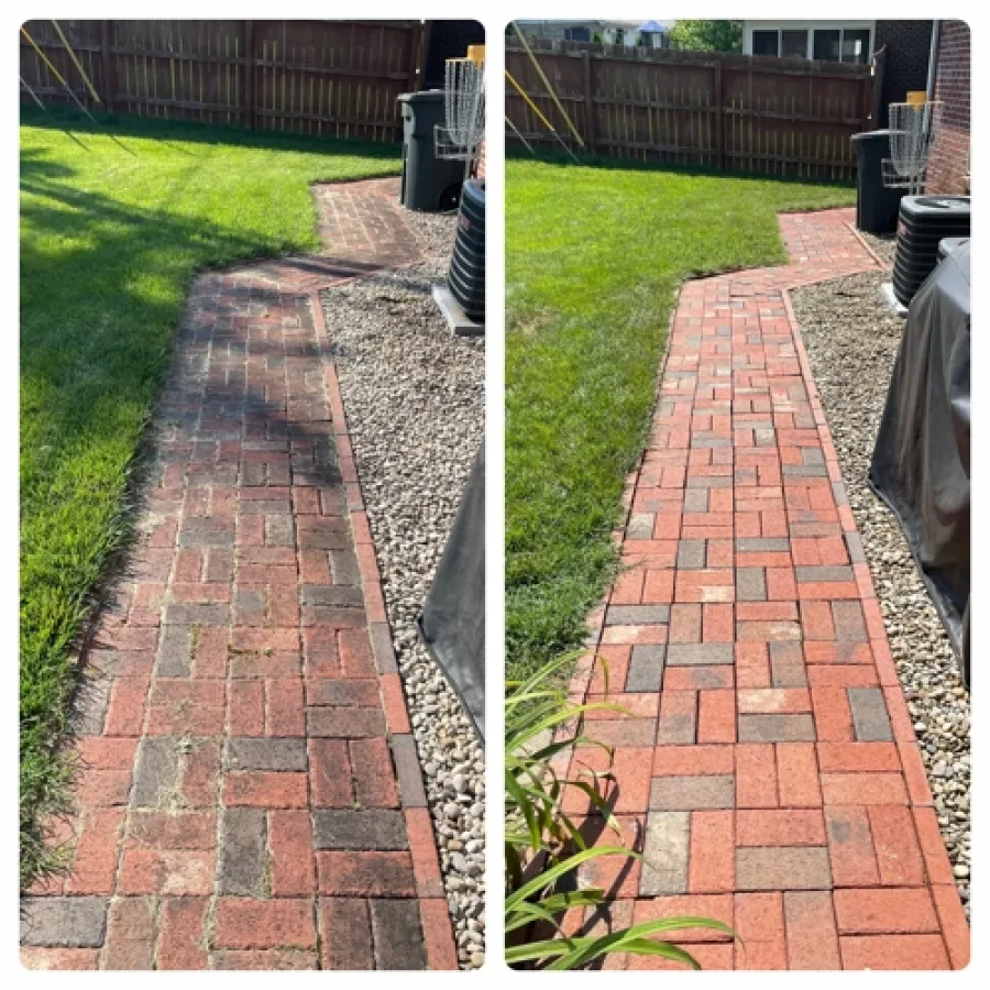 a brick walkway with grass and a brick path