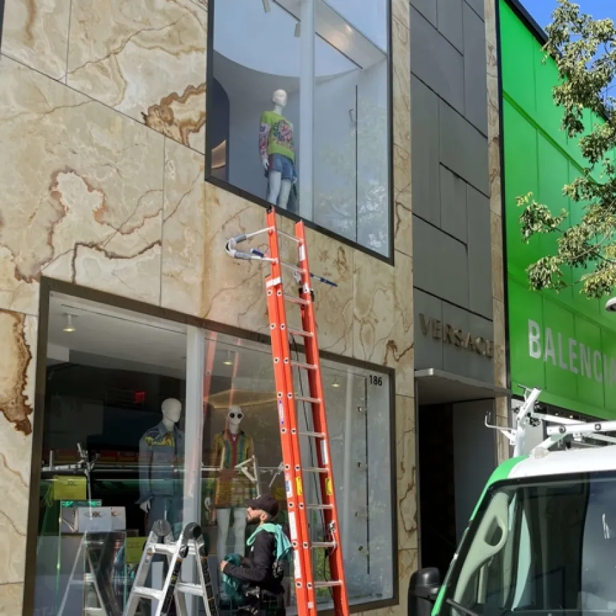 a person on a ladder next to a building