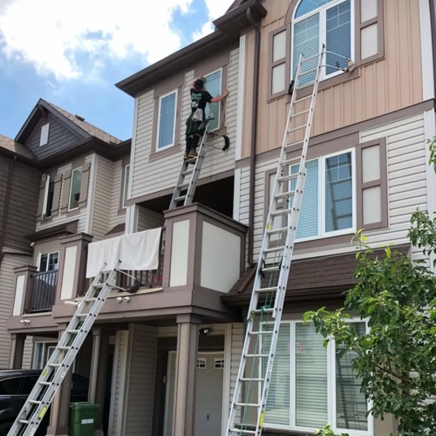 a person on a ladder on a building