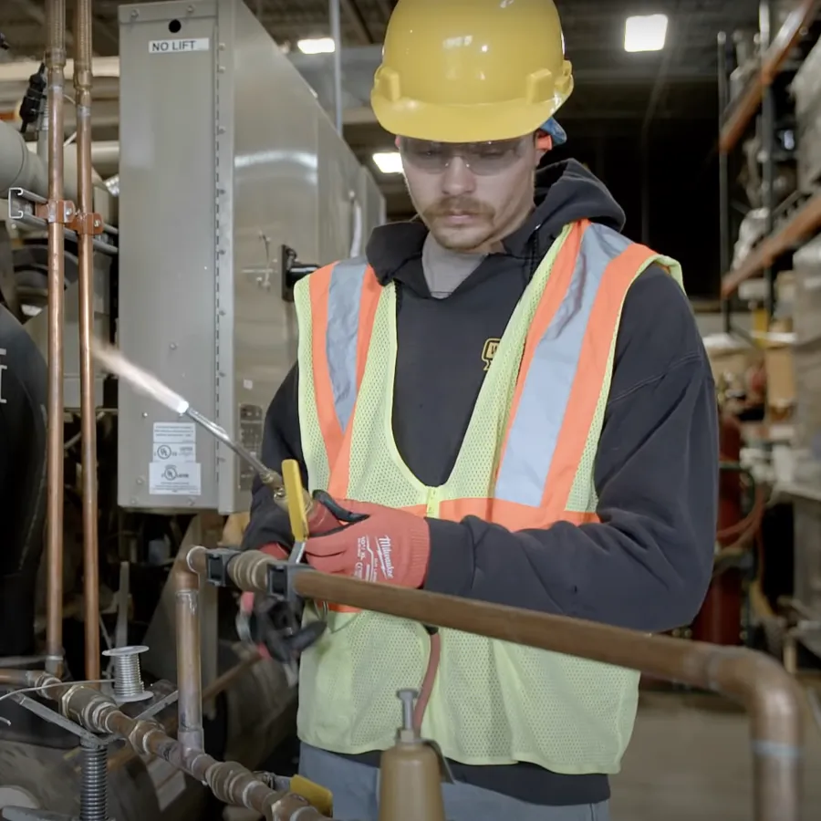 a person in a safety vest working in a factory