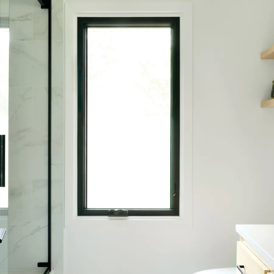 Minimalist bathroom with large black casement window