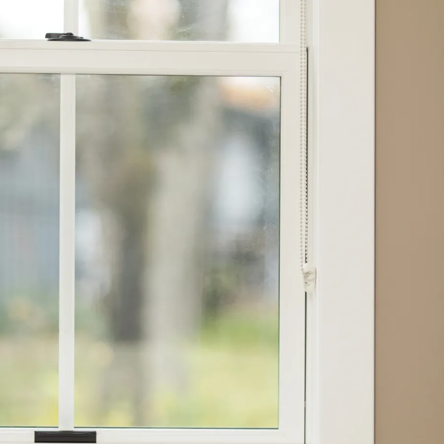 a window with a view of a field and trees outside