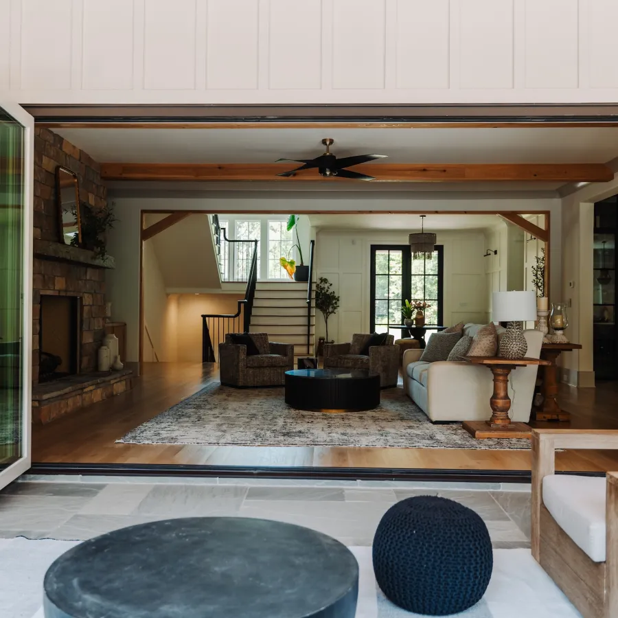 a living room with a large door leading out to covered porch