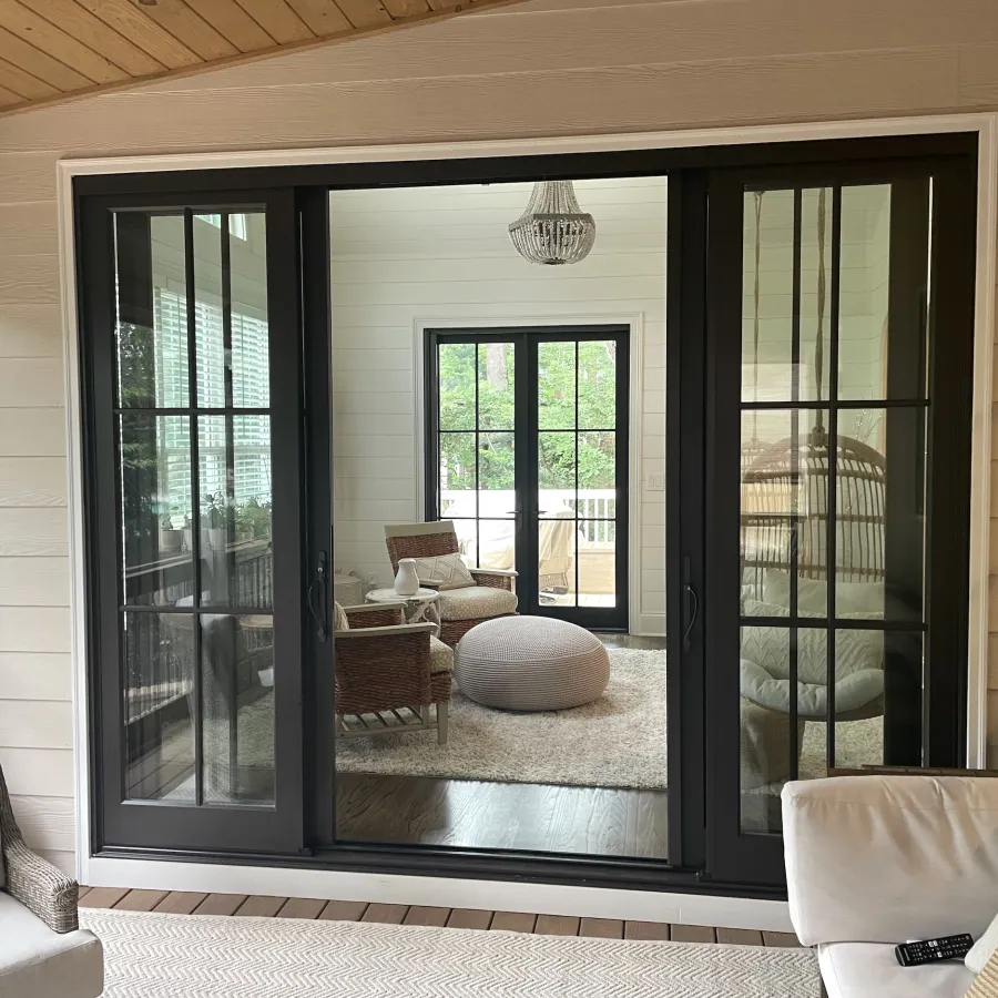 Sliding French doors connect enclosed porch and living room 