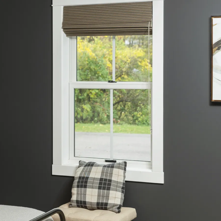 Interior view from inside a bedroom with dark gray walls of a white double hung fiberglass window 