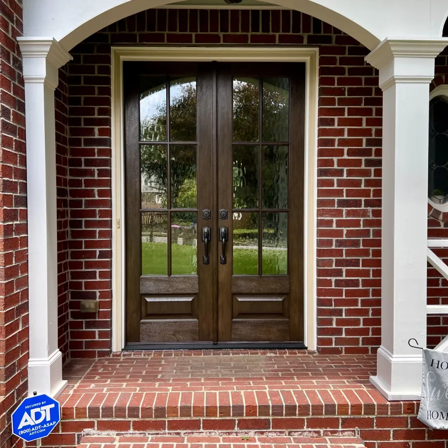 Brick house with fiberglass front doors with decorative privacy glass