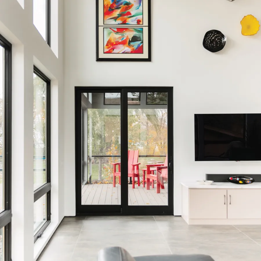 Modern living room with black French Doors leading onto deck.