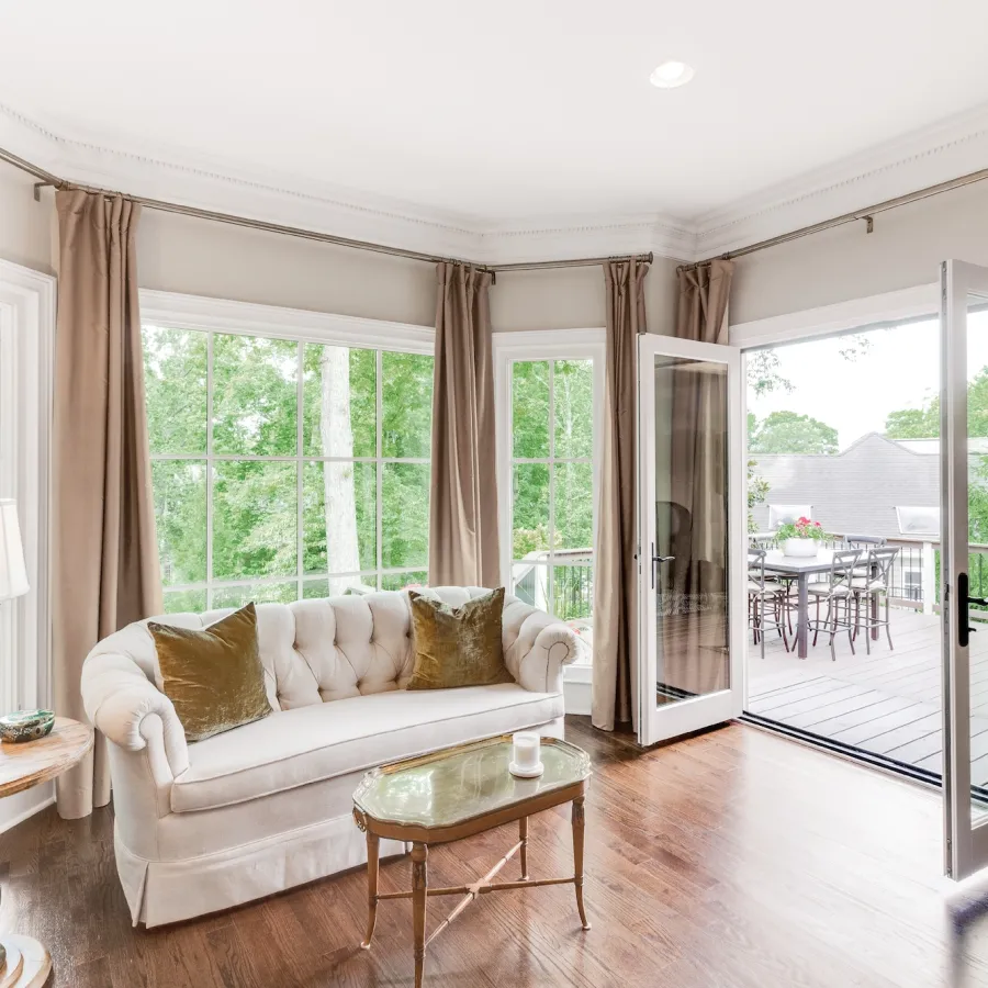 Master bedroom seating area with open French doors leading to the balcony.