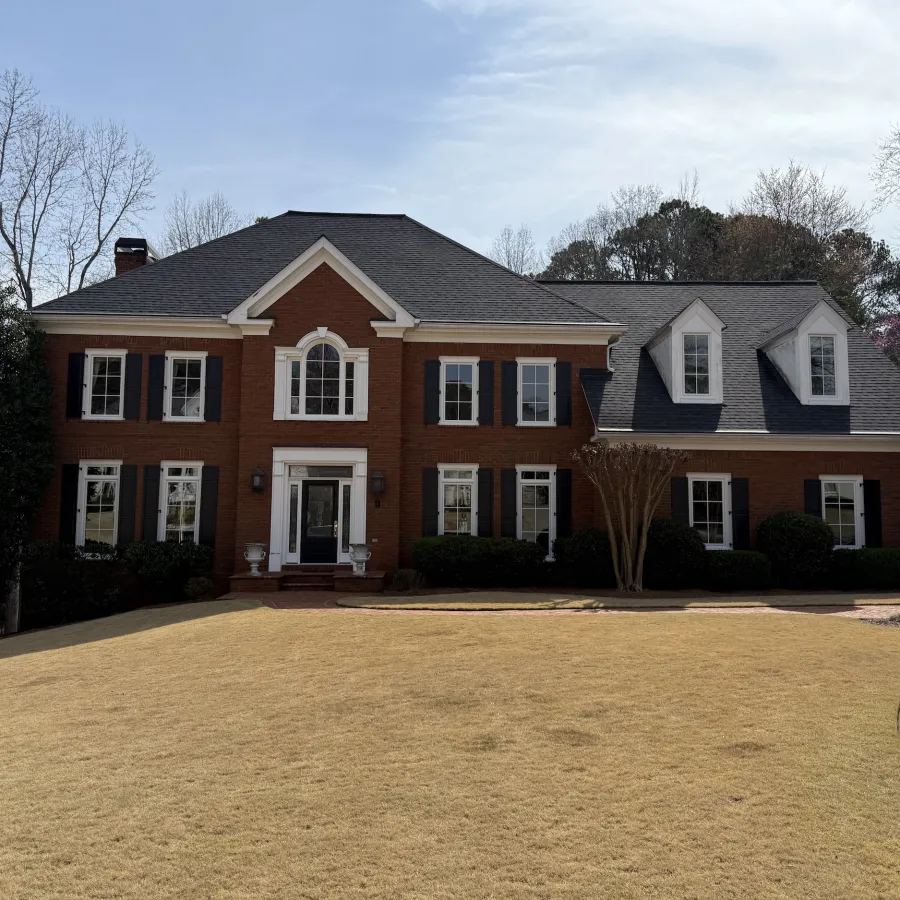 Elegant brick family home with white fiberglass windows with grids