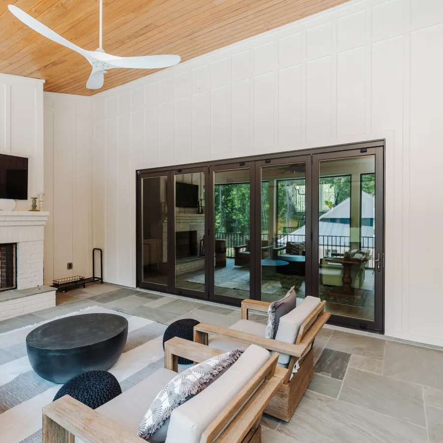 Black bifold fiberglass doors on outdoor living space