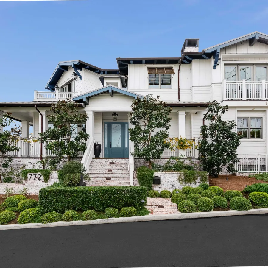 Large White House with blue front door with sidelights
