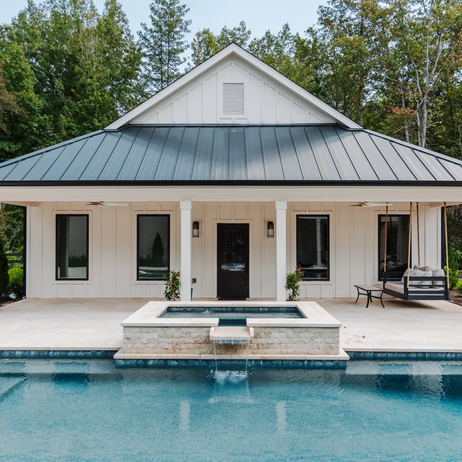 White pool house with black Infinity from Marvin Casement windows