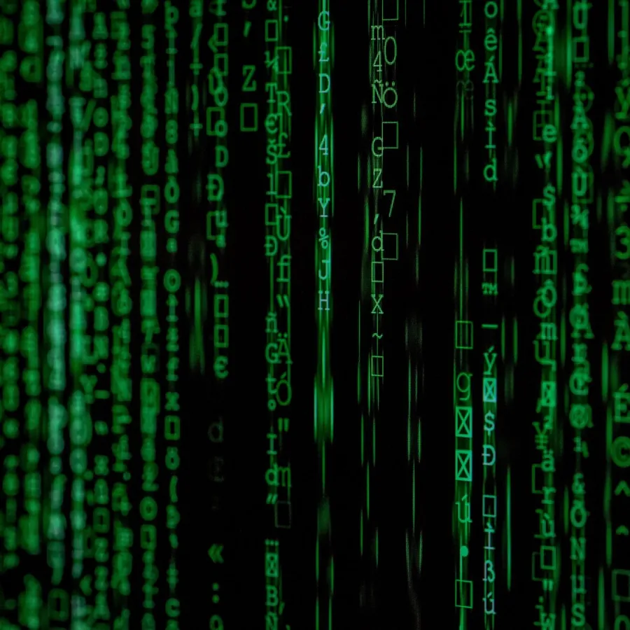 Green glowing matrix-style digital code cascading vertically on a black background representing data streams.