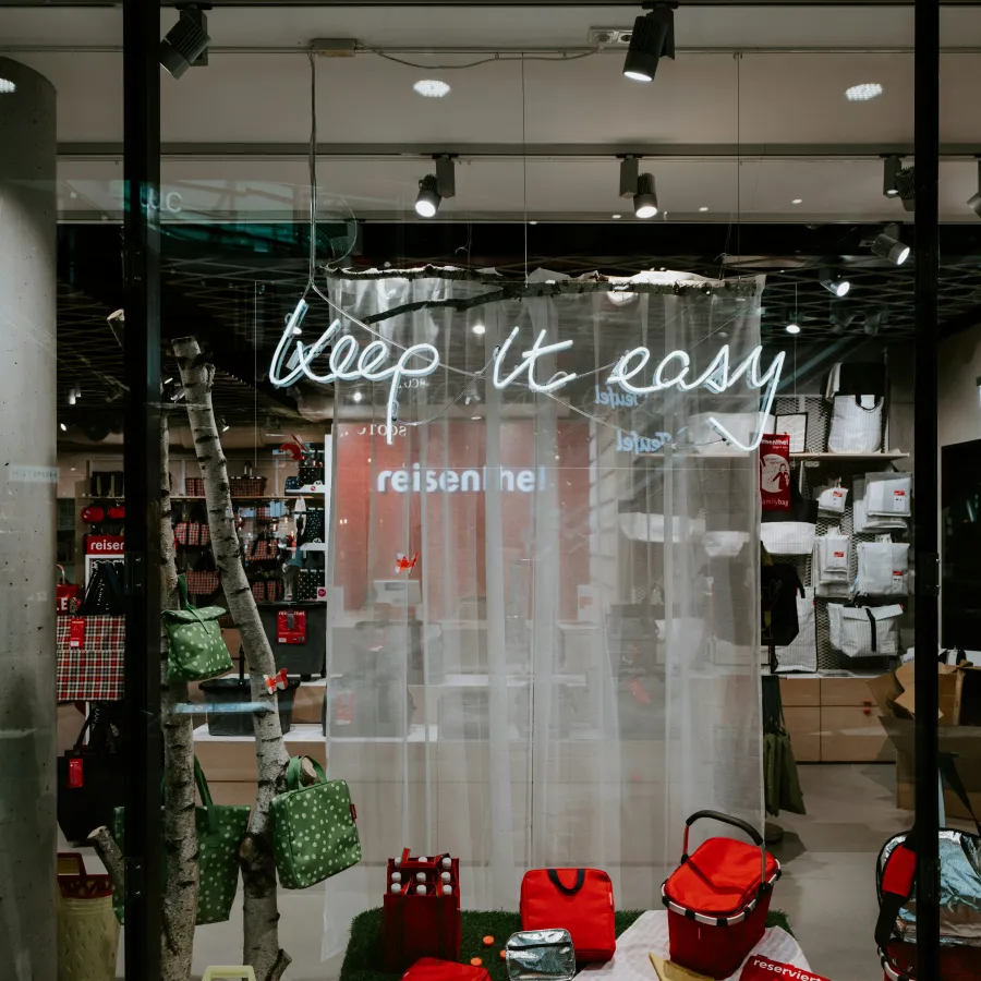 a store window with a display of shoes and bags