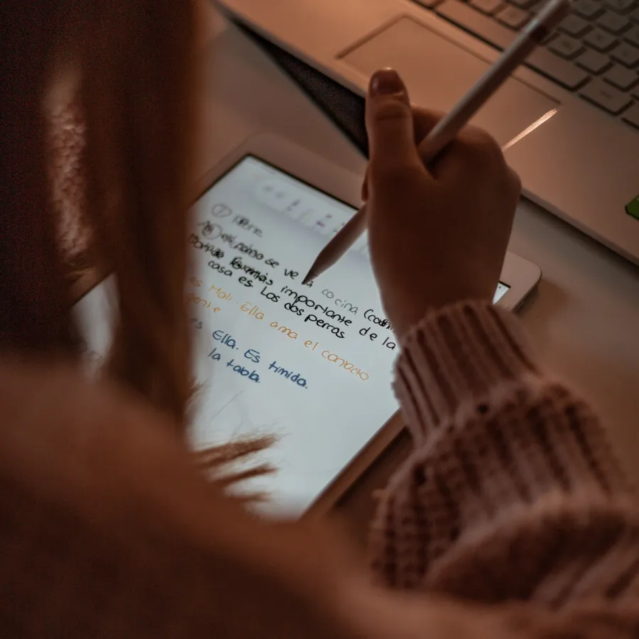 a person writing on a piece of paper