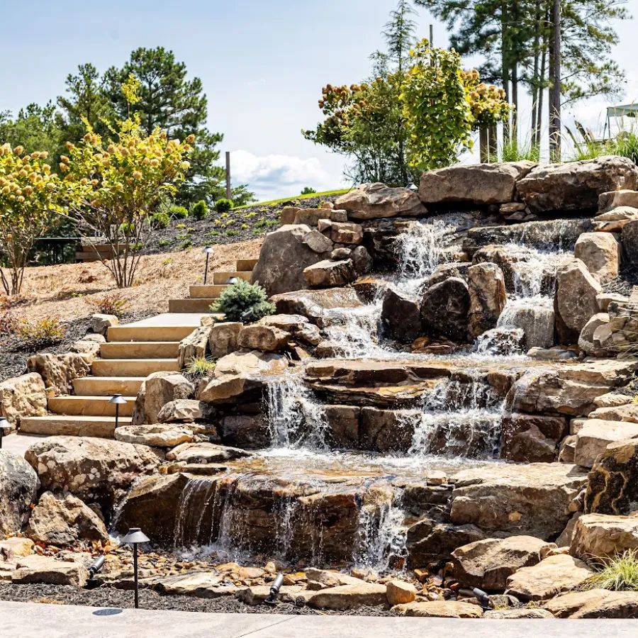 a stone staircase with rocks and trees