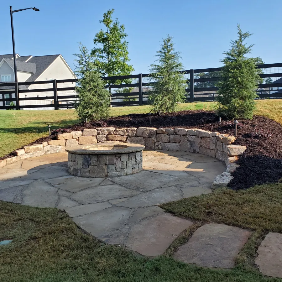 a stone fountain in a yard