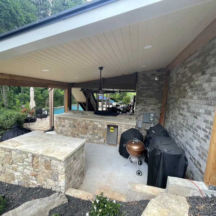 a patio with a chair and a fireplace