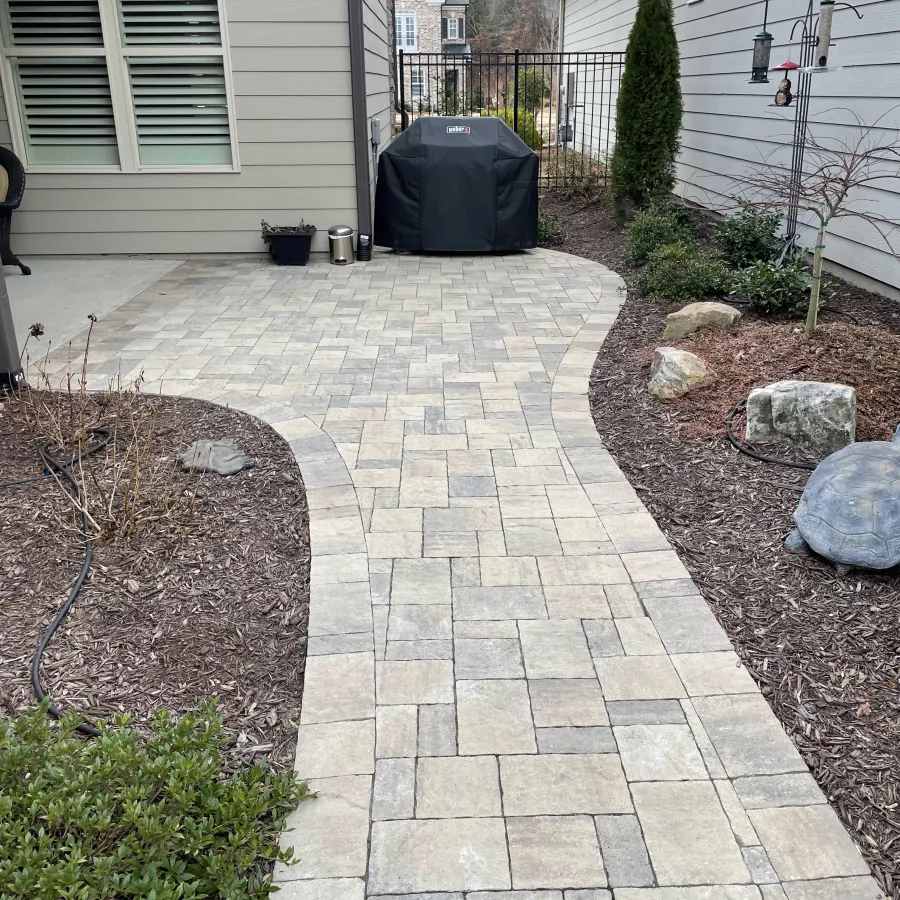 a brick walkway between houses