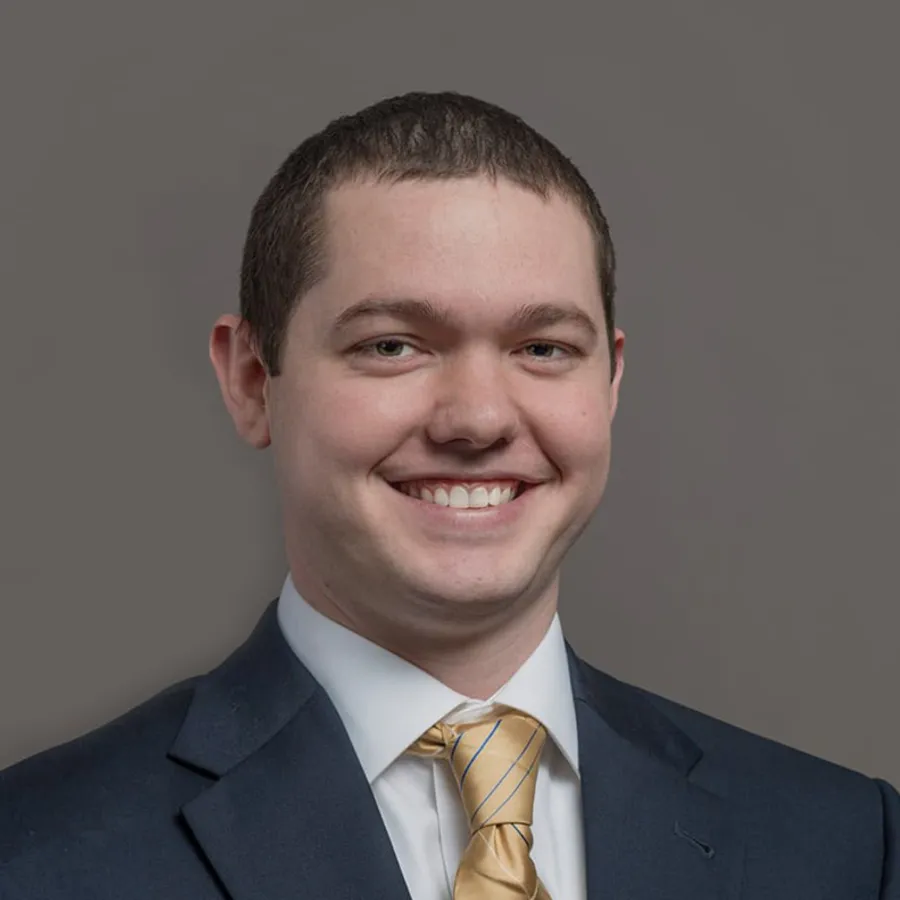 a man in a suit smiling