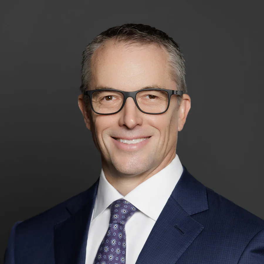 a man wearing glasses and a suit