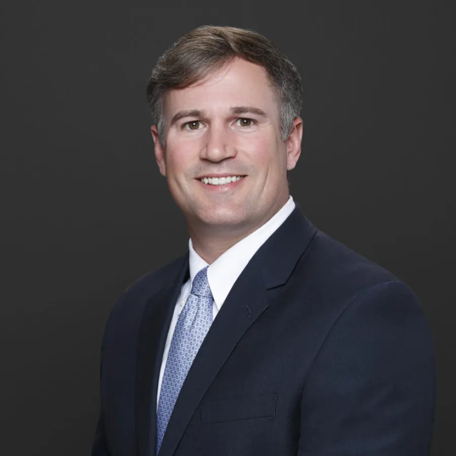 a man in a suit smiling