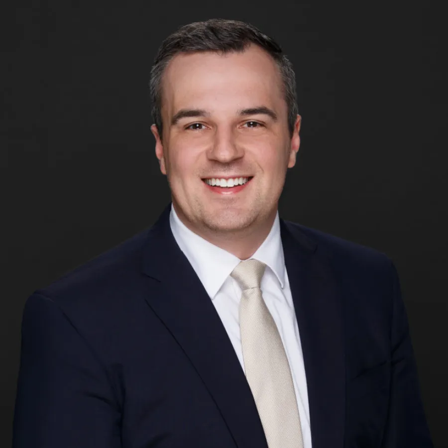 a man in a suit smiling