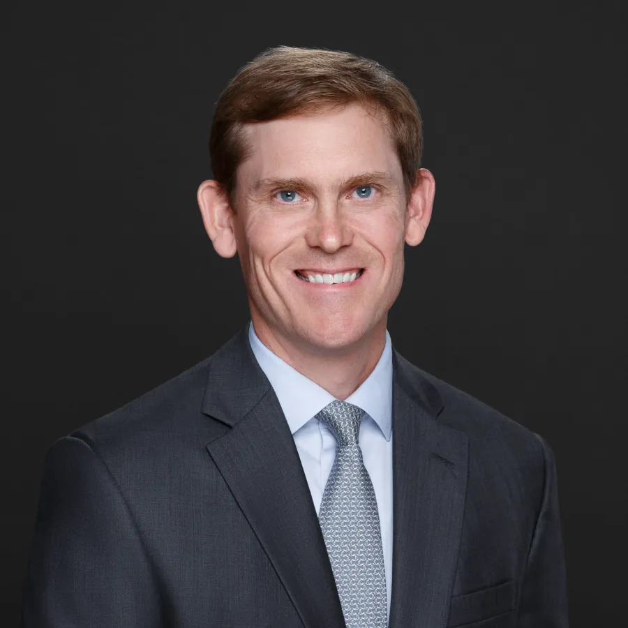 a man in a suit smiling