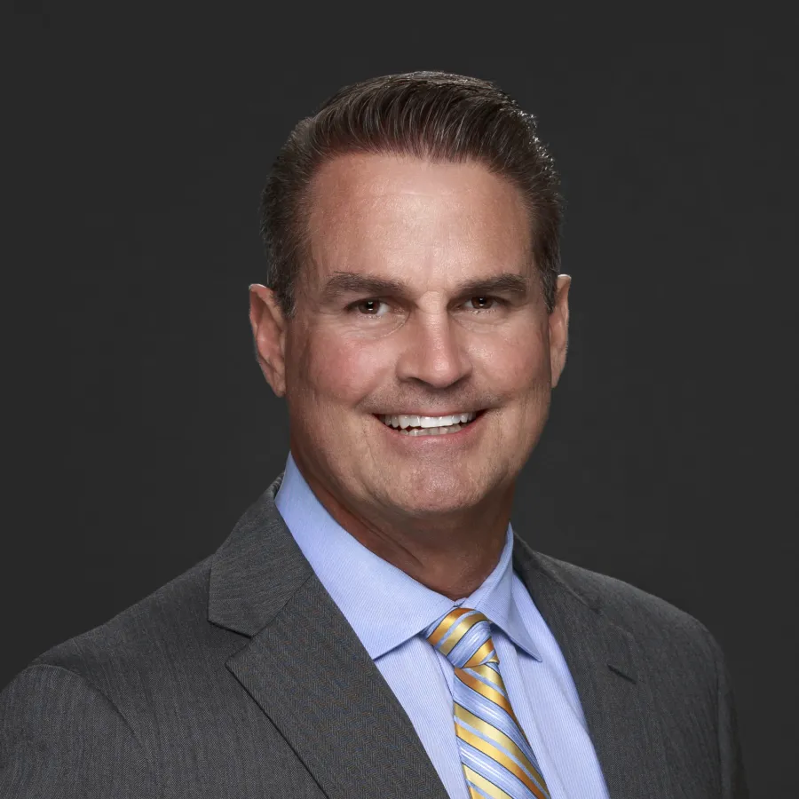 a man in a suit smiling