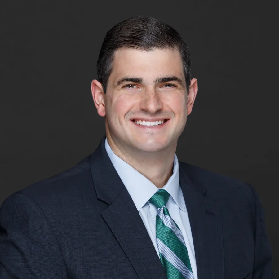 a man in a suit smiling