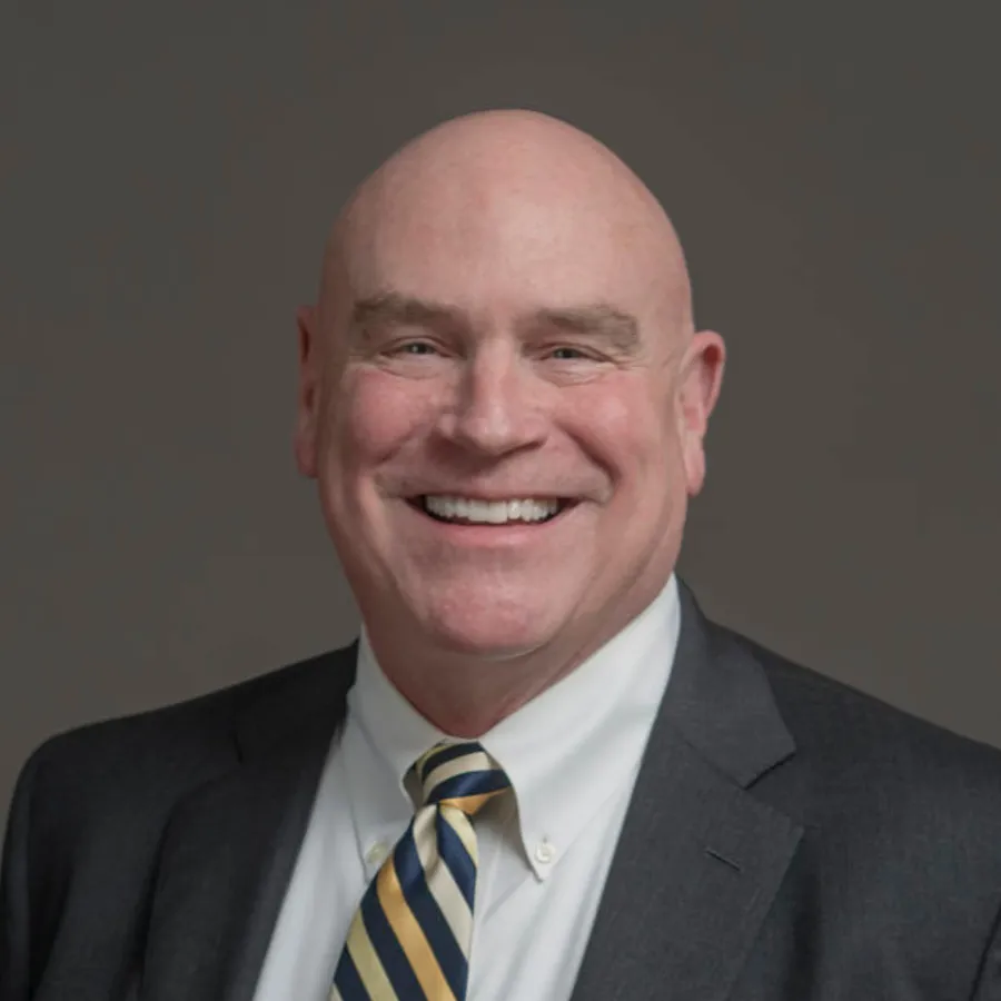 a man in a suit smiling