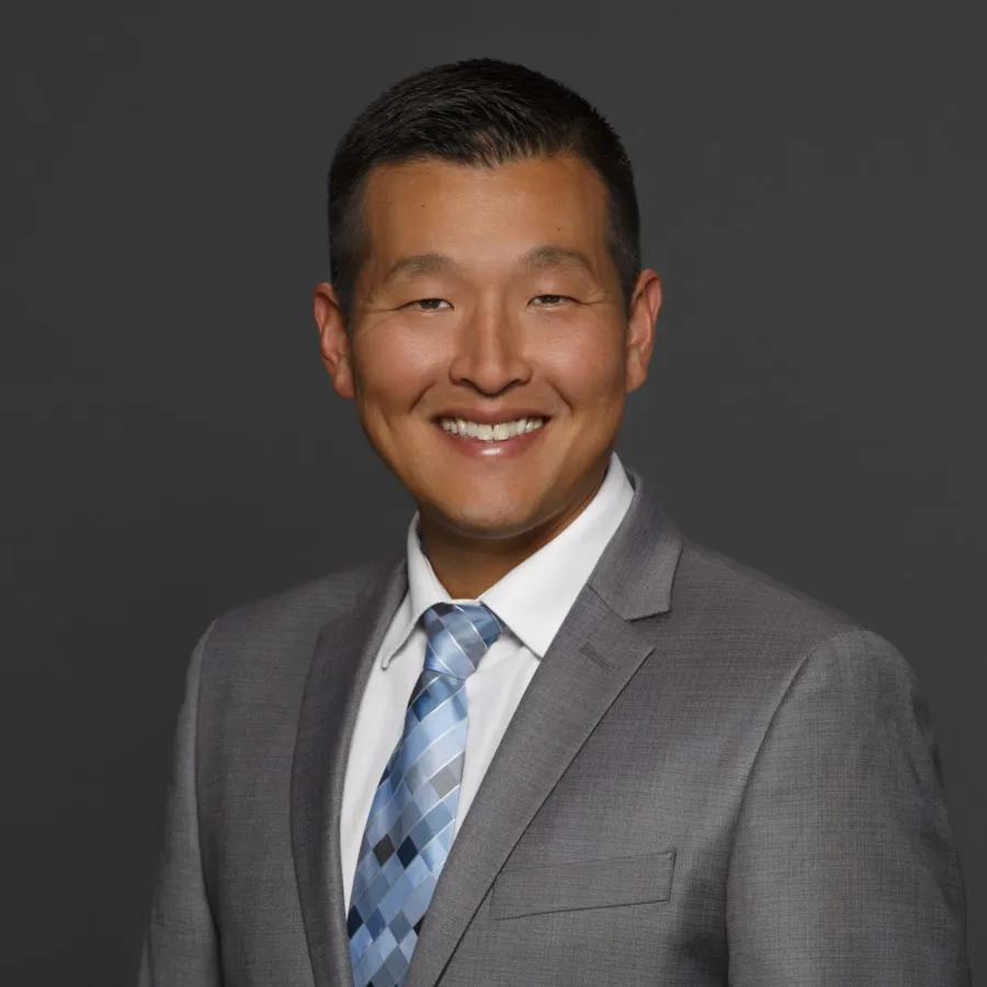 a man in a suit smiling
