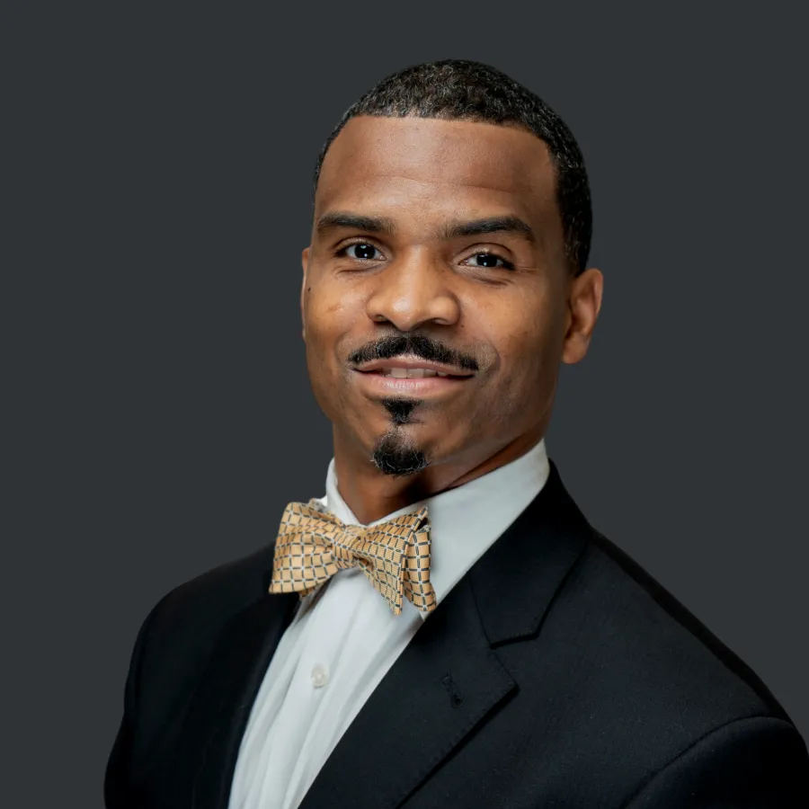 a man in a suit and bow tie