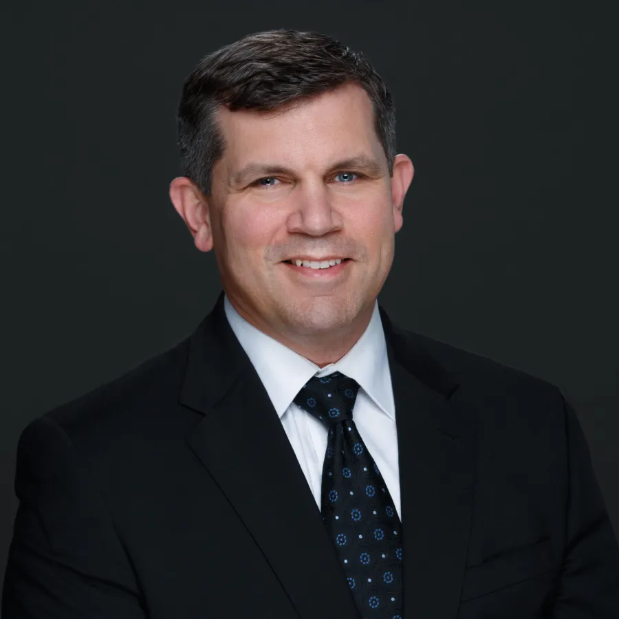 a man in a suit smiling