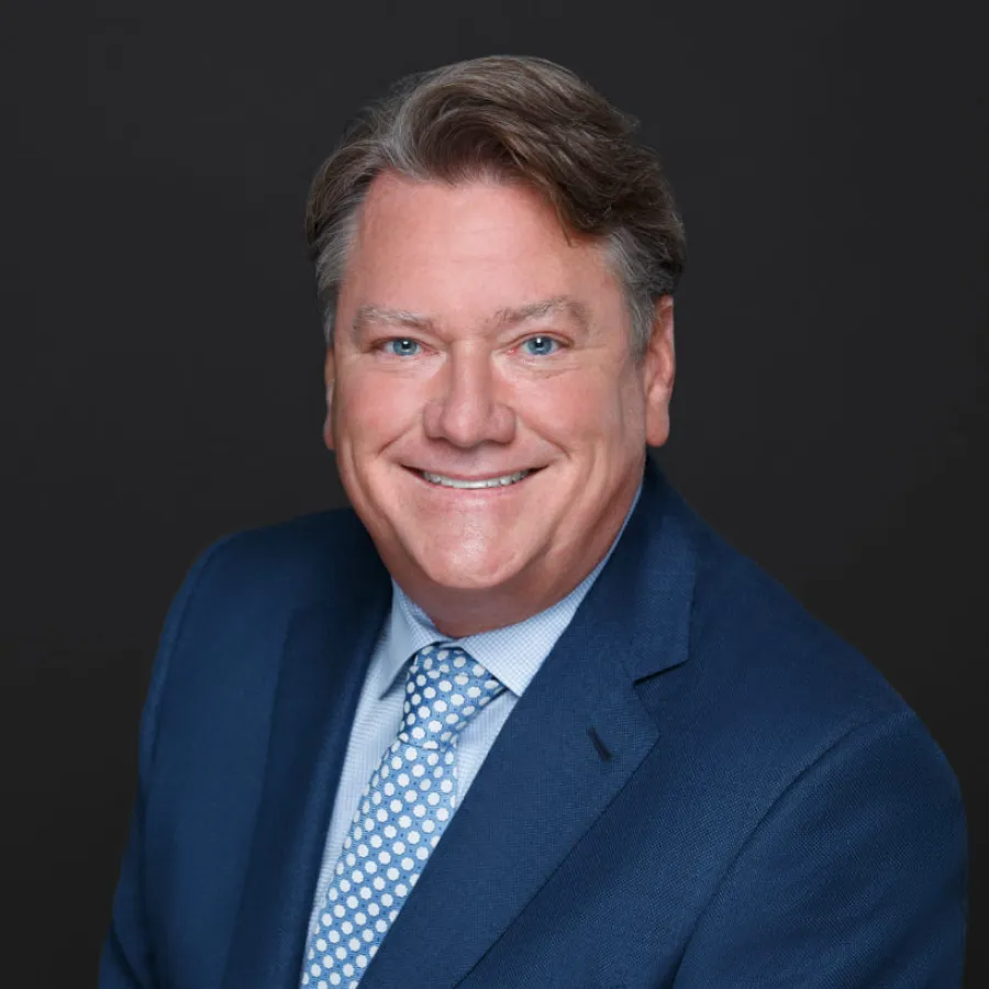 a man in a suit smiling